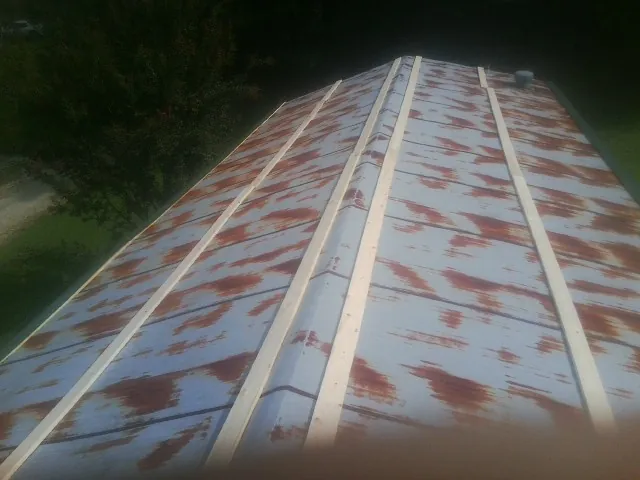 Rusted metal roof panels with new wood purlins before replacement — Storm Damage Roof Repair in Beech Bottom by Roofing Brothers