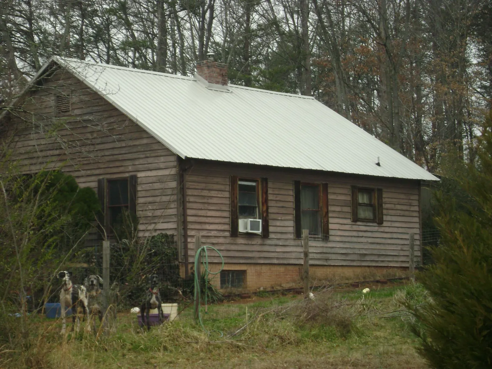 White metal roof on an old wood sided farmhouse, from a Metal Roof Installation job in Beech Bottom